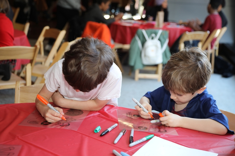 Decorating shadow puppets at Asia Society's Family Day