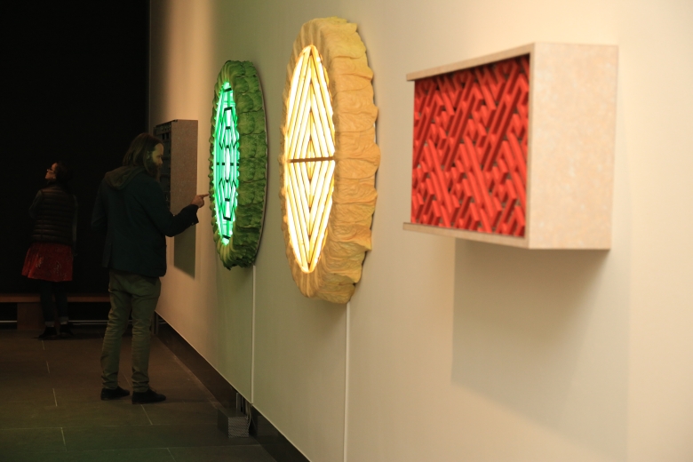 Installation view of Adrian Wong's three neon grate artworks in green, yellow and red in Breathing Space at Asia Society Hong Kong Center.