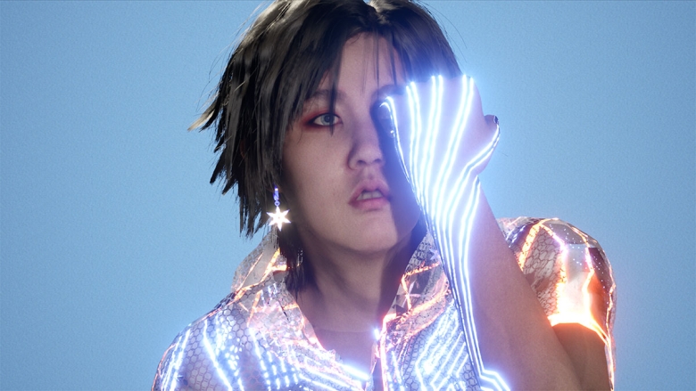 An image of the non-binary digital avatar Dokusho Dokushi (aka Doku). Their outfit is lined with bright, electric-looking patterns. They gaze out at the viewer with one hand in a fist held in front of their face. 