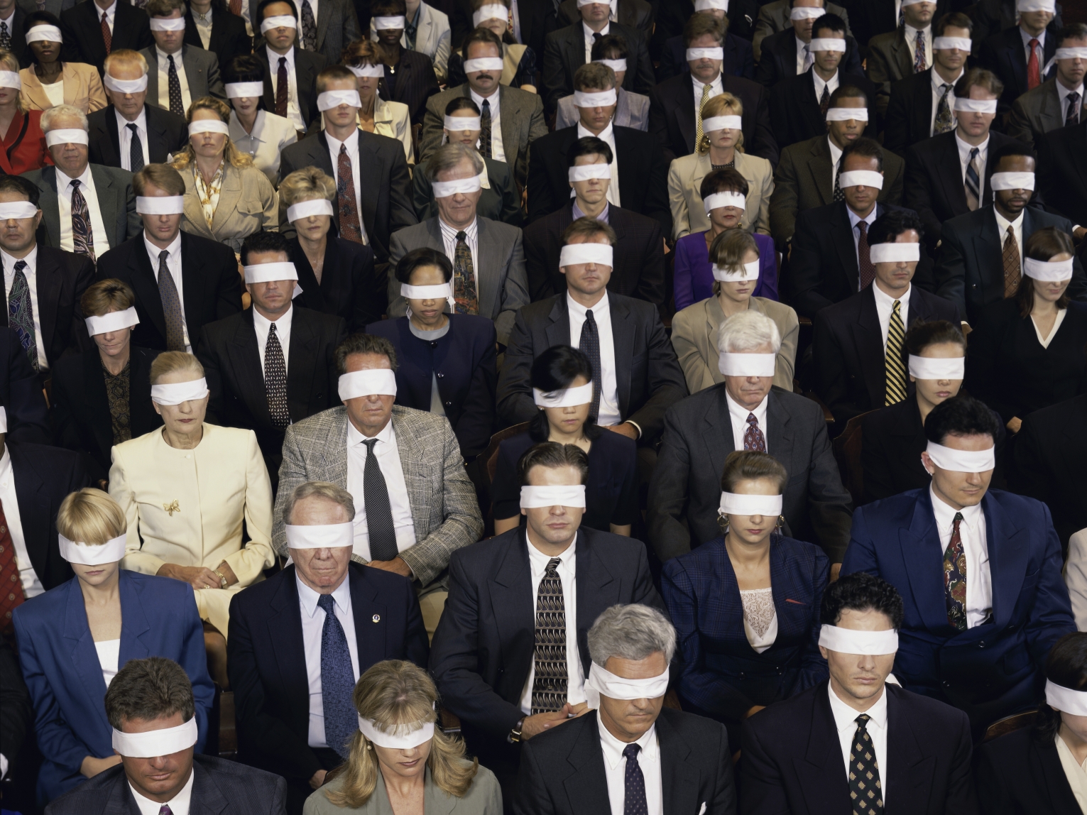 A crowd of blindfolded people