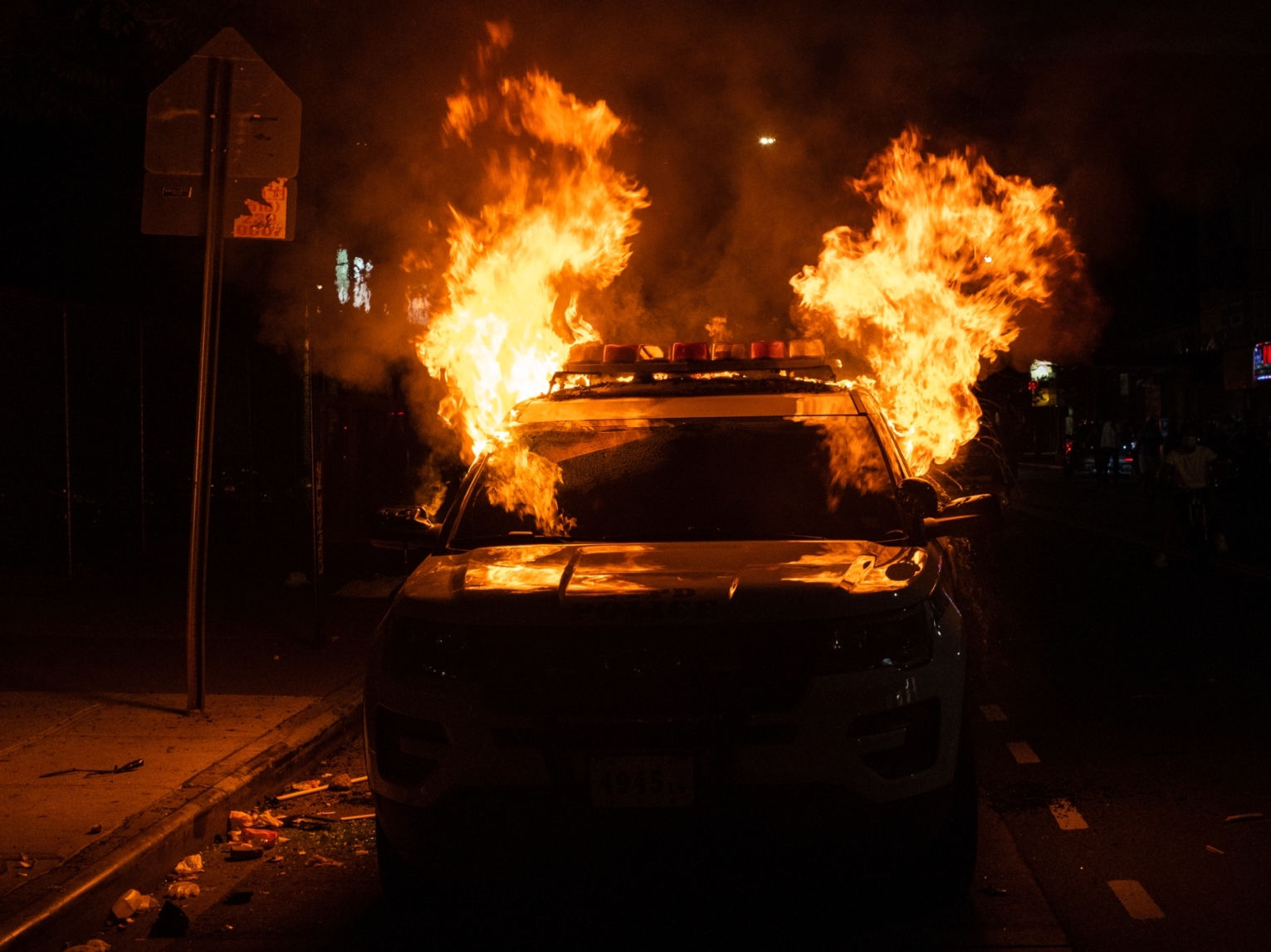 Flames engulf a New York Police Department (NYPD) vehicle in Flatbush, Brooklyn, on May 30, 2020.