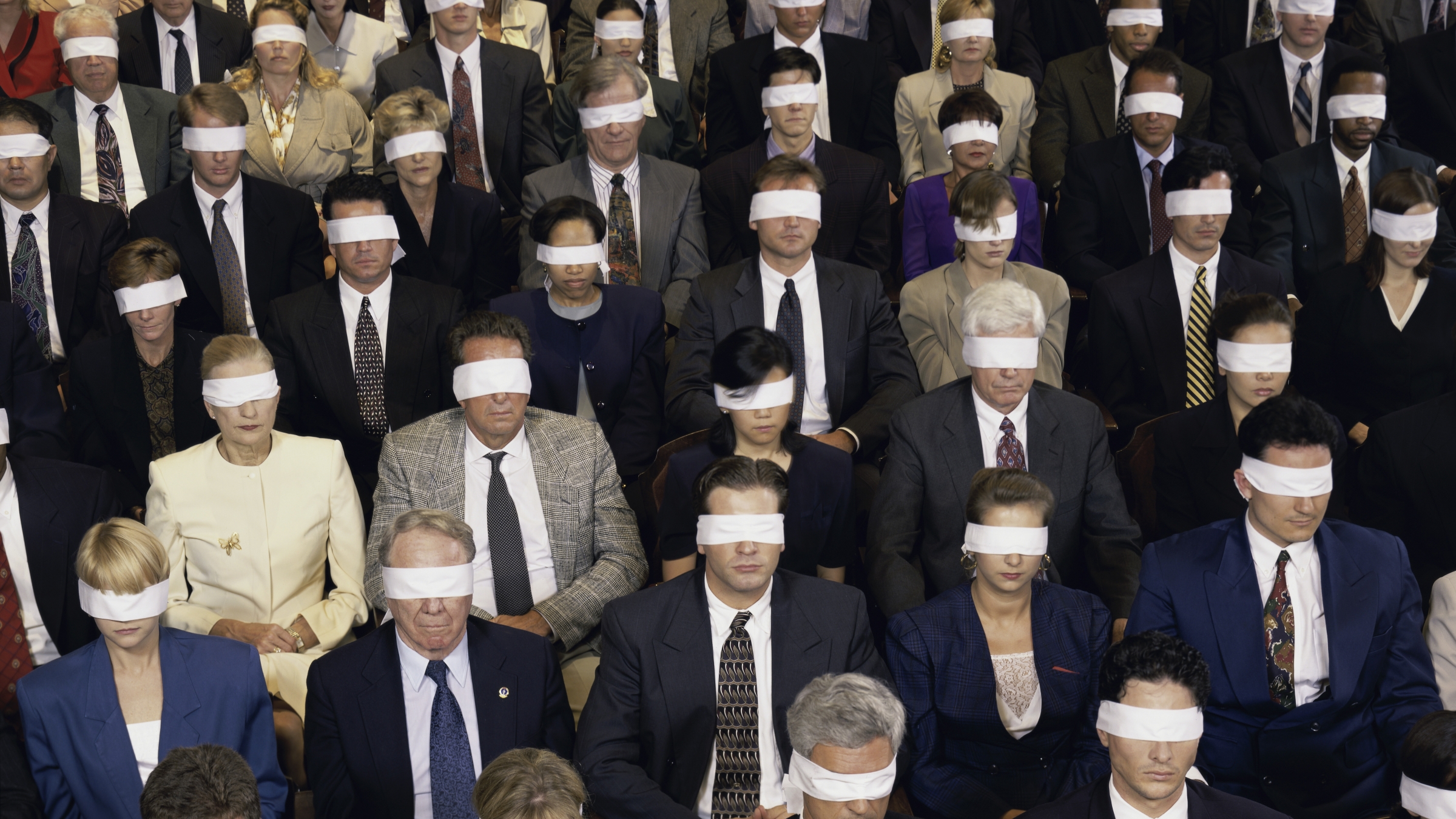 A crowd of blindfolded people