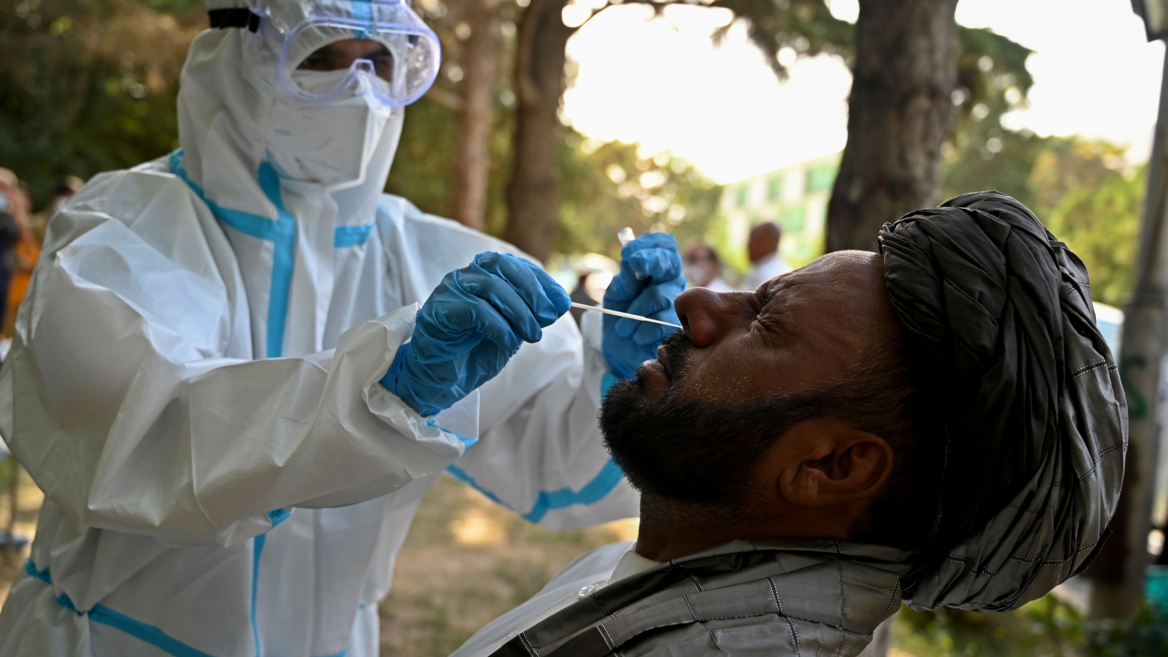 An Afghan man is tested for COVID-19